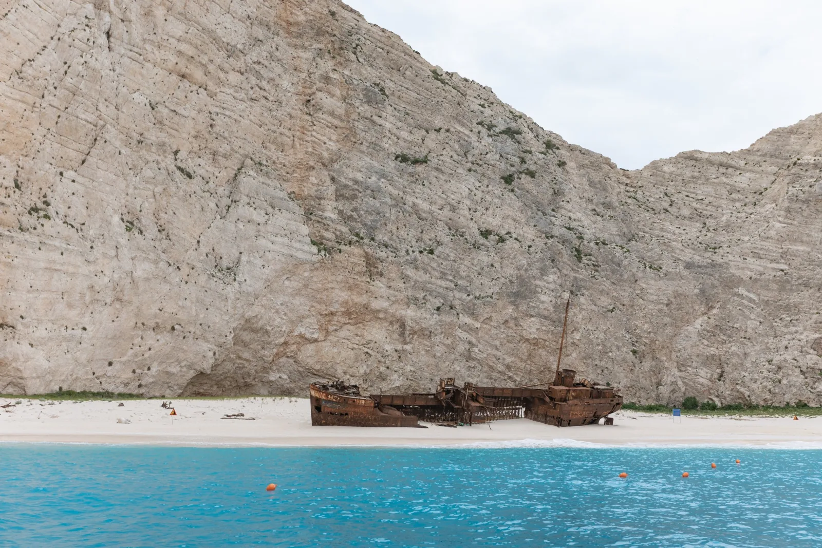 Navagio cove seen from offshore, the wreck on the sand beneath sheer cliffs